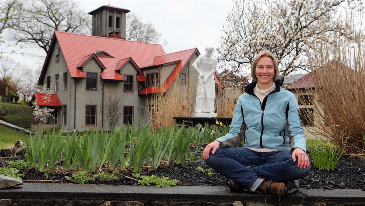 Amy Reyer, who leads meditation classes at the Graymoor Spiritual Life Center in Garrison, is pictured with the historic St. Francis Chapel on the property April 25, 2017.