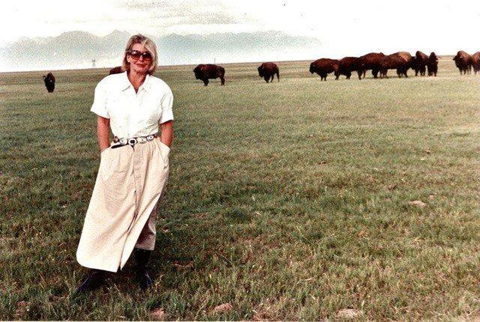 Hanne Strong stands in the San Luis Valley with a herd of Buffalo, in an undated photo used by her Manitou Foundation.