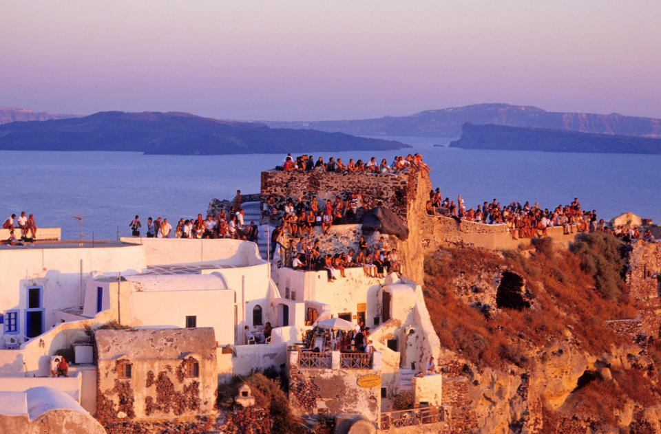 Tourists watching the sunset in Santorini